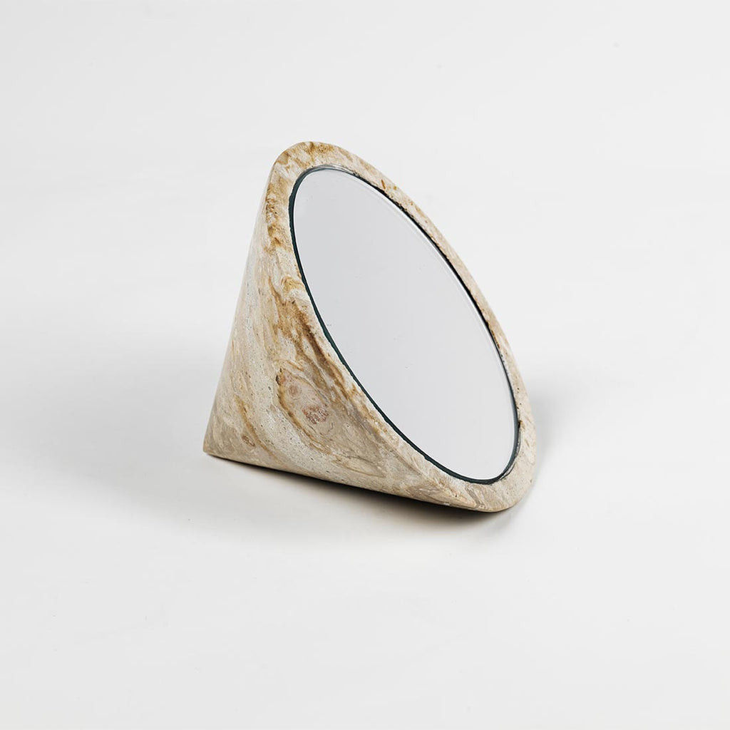 A small SPINNING TOP MIRROR by KRISTINA DAM STUDIO on a white surface at Gestalt Haus.