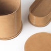A pair of Kristina Dam Studio leather boxes with handles and Gestalt-inspired stitching.