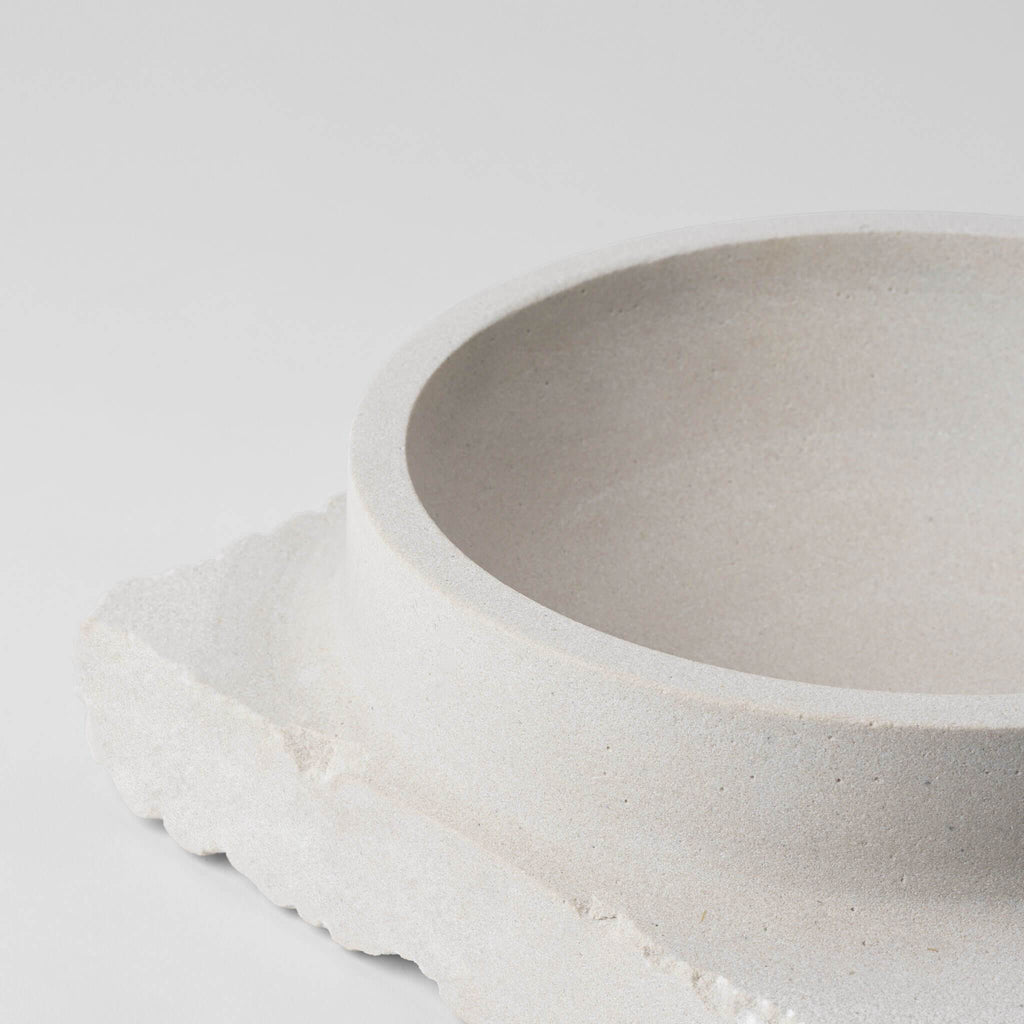 A LACUNA SHAPE bowl sitting on top of a white surface by KRISTINA DAM STUDIO, showcasing Gestalt design.