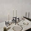 A Gestalt Haus table with STOFF NAGEL LED candles and plates.