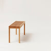 A lightweight bench by FORM & REFINE displayed on a white background.
