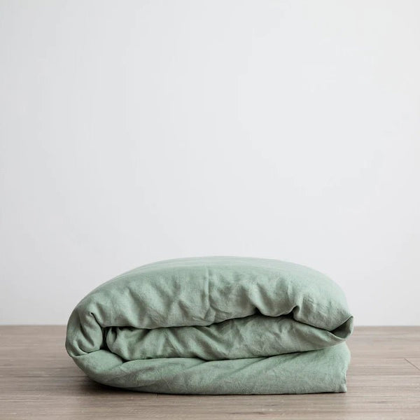 A LINEN DUVET COVER on top of a wooden table from CULTIVER, nestled in Gestalt Haus.