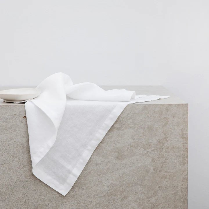 A white linen napkin sitting on top of a concrete slab at Gestalt Haus.