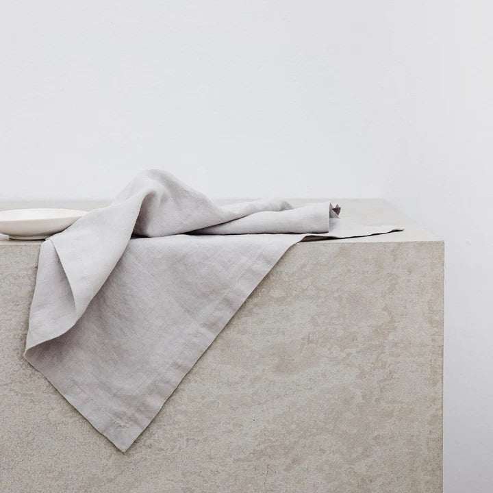 A Cultiver linen napkin sitting on top of a concrete slab at Gestalt Haus.