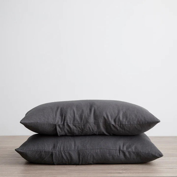 Two CULTIVER grey LINEN PILLOWCASES stacked on top of each other.