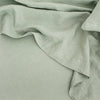 A close up image of a green CULTIVER LINEN SHEET SET (FITTED + FLAT) WITH PILLOWCASES linen sheet featured at Gestalt Haus.