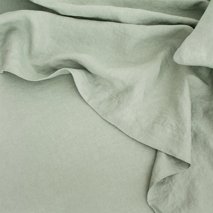 A close up image of a green CULTIVER LINEN SHEET SET (FITTED + FLAT) WITH PILLOWCASES linen sheet featured at Gestalt Haus.