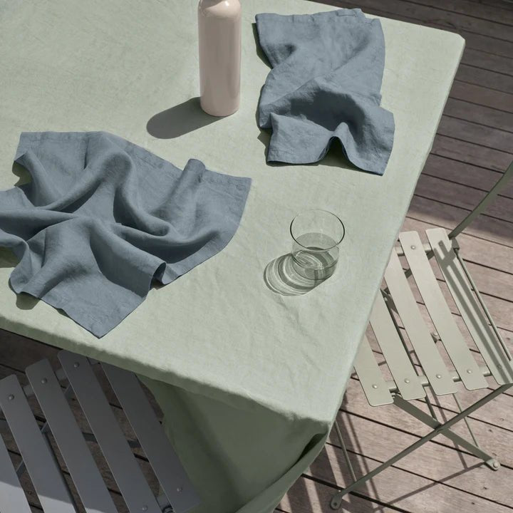 A table with two chairs and a LINEN TABLECLOTH from CULTIVER at Gestalt Haus.