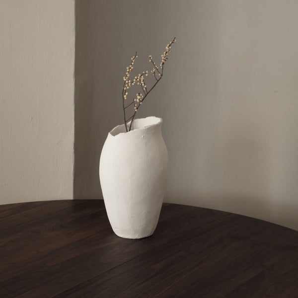 A MAGNOLIA VASE by SIBAST enhances the aesthetic of the wooden table in a Gestalt Haus.