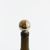 A Gestalt Haus bottle stopper on a white background.