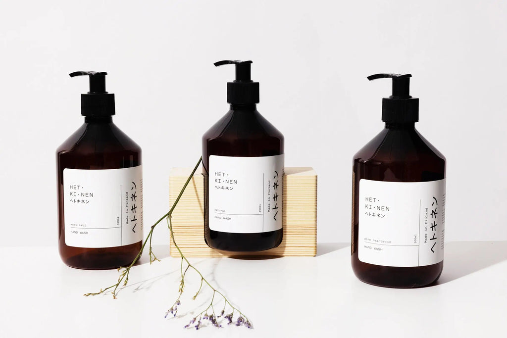 Three bottles of Hetkinen Natural Hand Soap on a wooden table at Gestalt Haus.