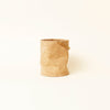 A small cork bin sitting on a white surface in the Gestalt Haus.