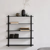 A NIVO SHELF E by GEJST featuring a black frame hangs on the wall alongside a vase.