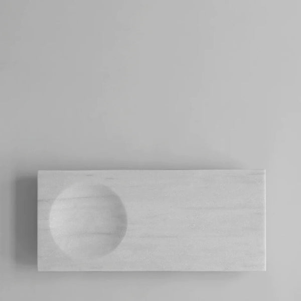 A Gestalt marble tray by 101 COPENHAGEN on a gray wall.