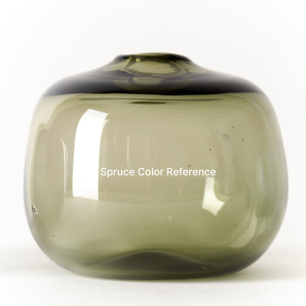A green glass OLIVE OIL CRUET with the words sprout designed by GARY BODKER DESIGNS.