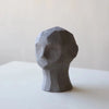 A COOEE OLUFEMI HEAD SCULPTURE displayed on a Gestalt Haus table.