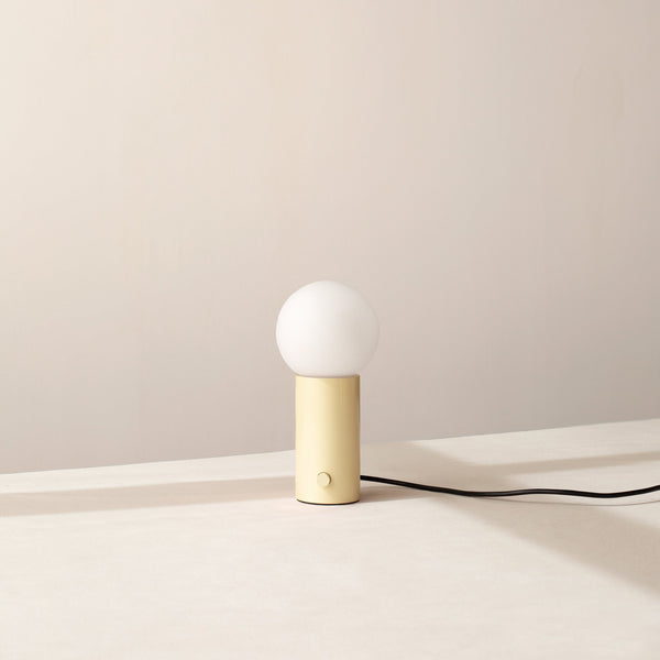 An ORB TABLE LAMP by IN COMMON WITH on a white table at Gestalt Haus.