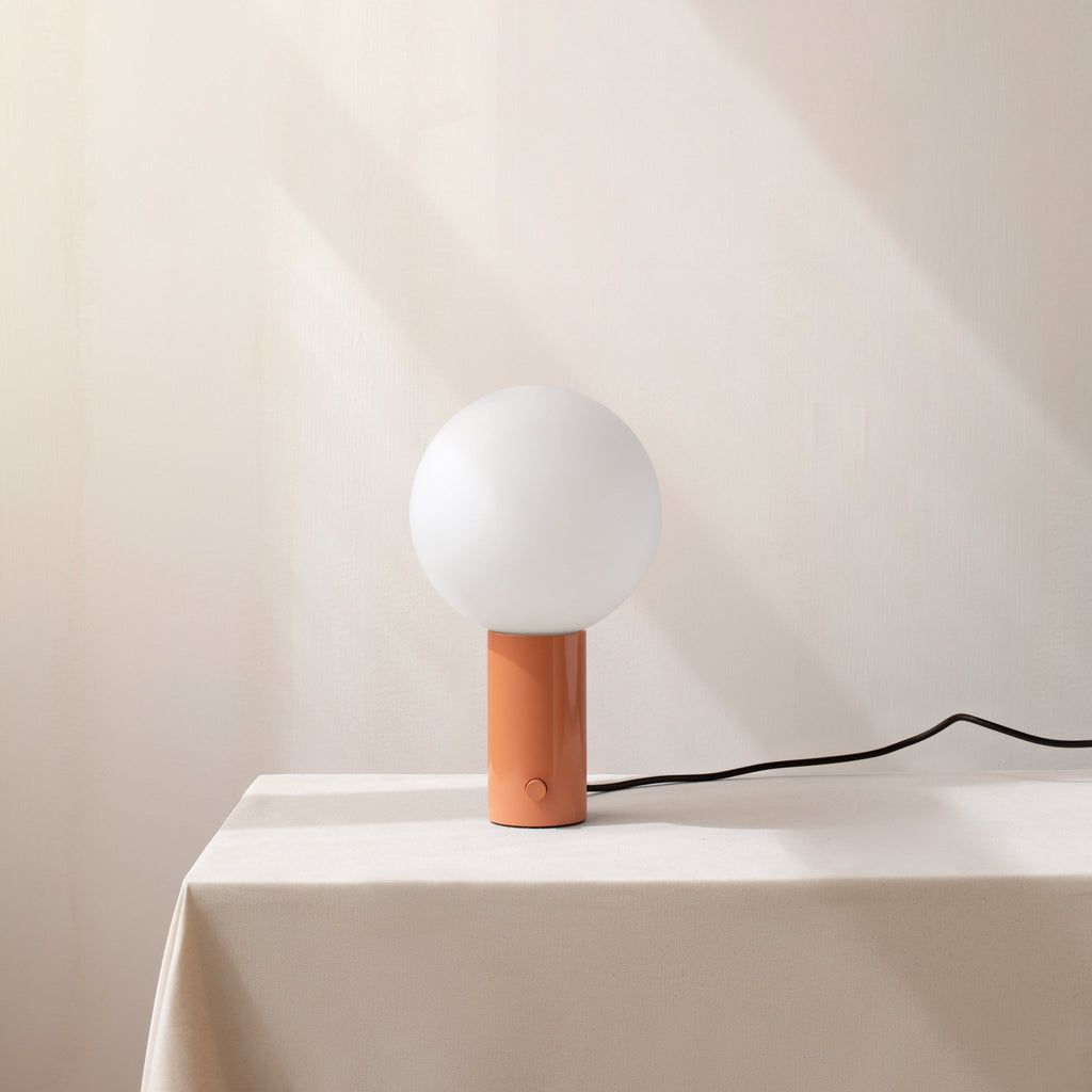 An Orb Table Lamp sitting IN COMMON WITH a window in the Gestalt Haus.