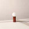 An ORB TABLE LAMP by IN COMMON WITH, on a white table at Gestalt Haus.