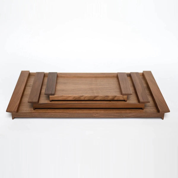 An ORIGIN MADE wooden serving tray with a wooden handle from Gestalt Haus.