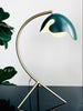 A PS38 TABLE LAMP with a green leaf on it, made by ATBO, inspired by the minimalist aesthetics of Gestalt Haus.