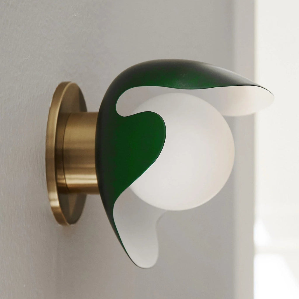 An ATBO PS38 WALL LAMP adorned with a charming green flower from Gestalt Haus.