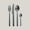 A set of Pascale Naessens' PURE FLATWARE on a grey background by SERAX.