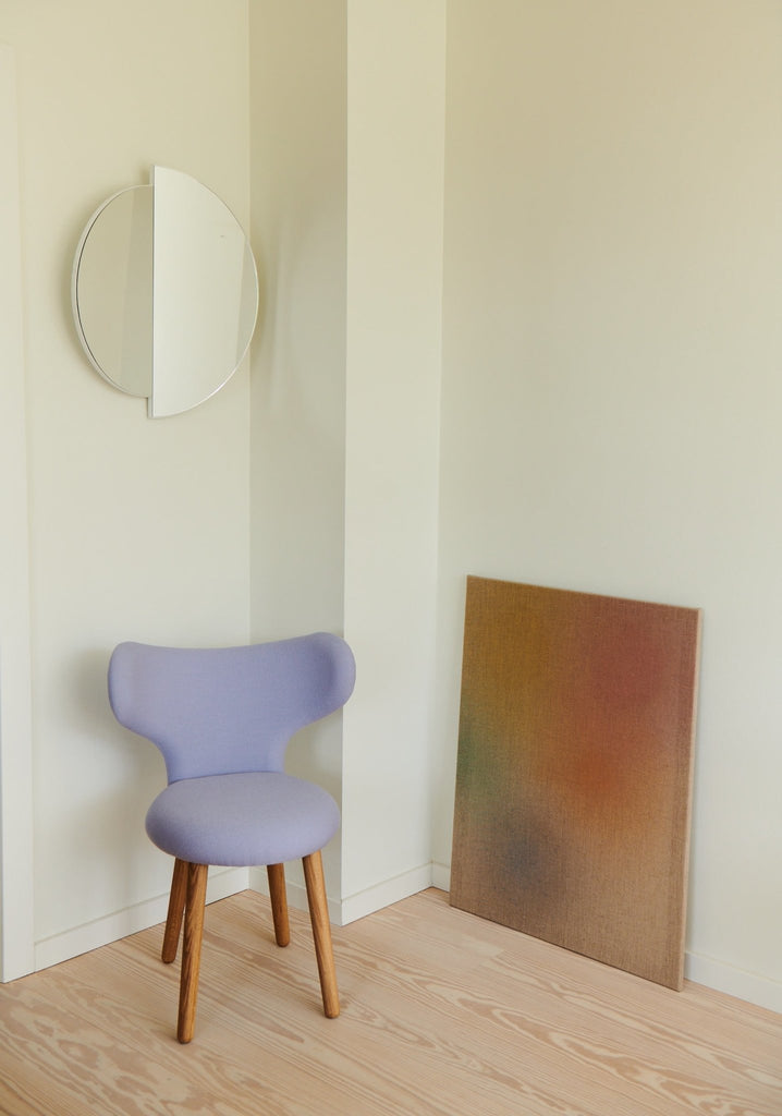 A Gestalt Haus chair in a room with a painting on the wall.