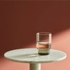 A glass from the RYE GLASSWARE COLLECTION by AARON PROBYN sits on top of a marble table at Gestalt Haus.