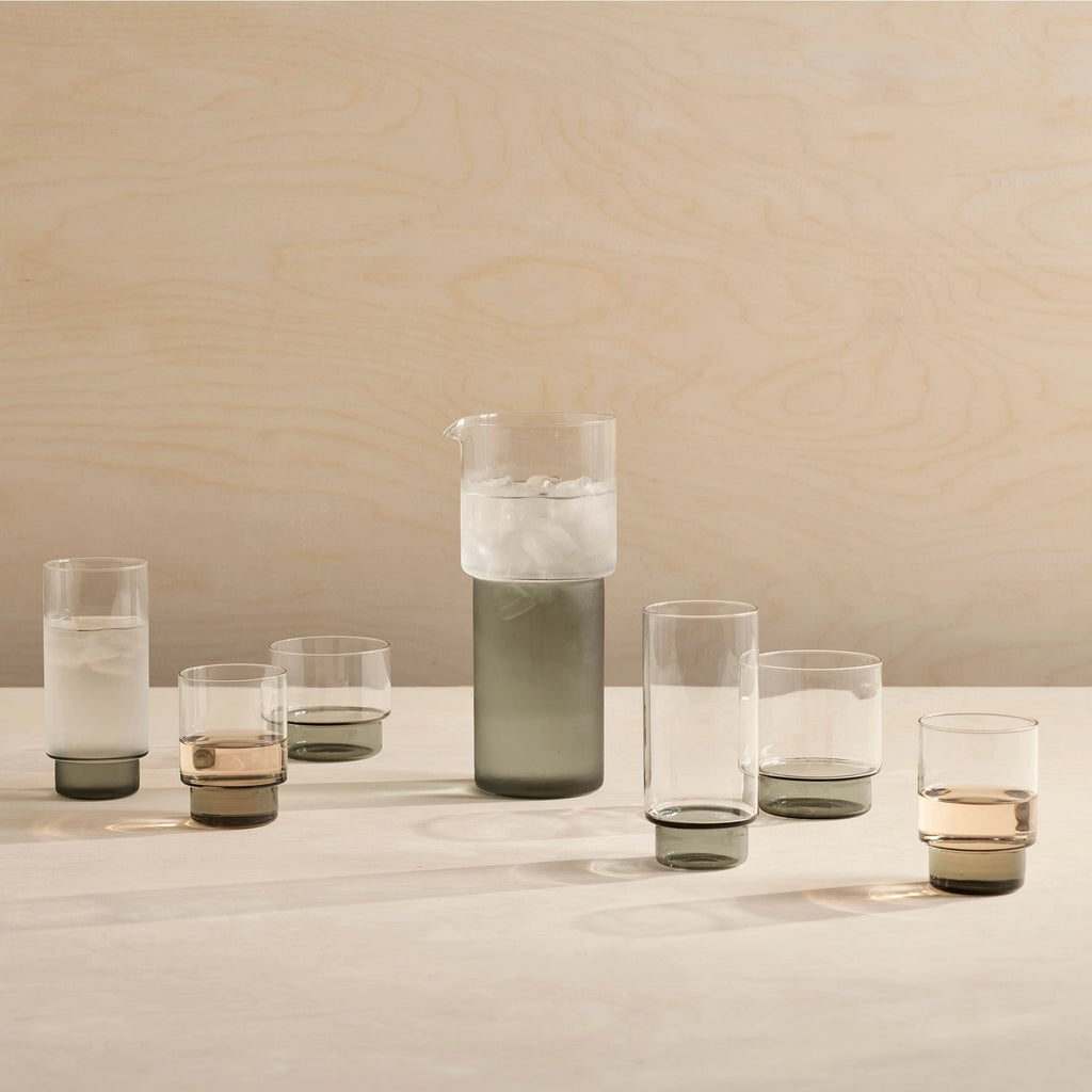A set of Rye Glassware Collection glasses and a pitcher by Aaron Probyn arranged on a table in Gestalt Haus.