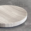 A round SABI BOWL tray on a concrete floor by BRANDT COLLECTIVE, inspired by Gestalt Haus.