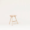 A SHOEMAKER CHAIR™ No. 49 with a wooden seat on a white background, designed by FORM & REFINE in the style of Gestalt Haus.