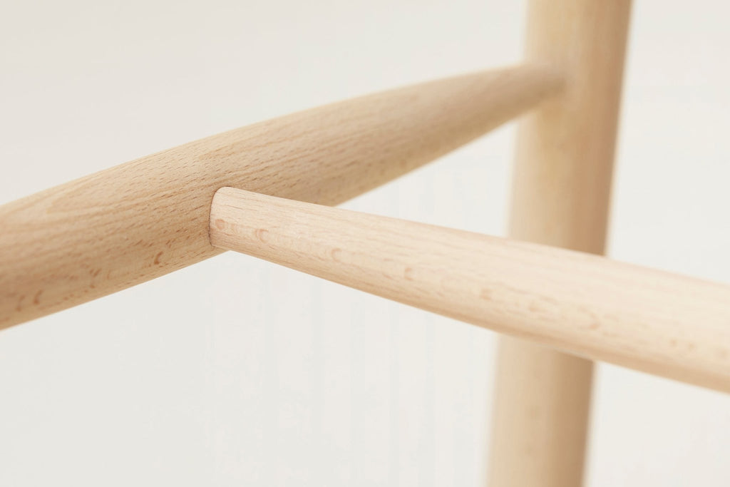 A close up of a FORM & REFINE SHOEMAKER CHAIR™ No. 68 with a wooden handle at the Gestalt Haus.