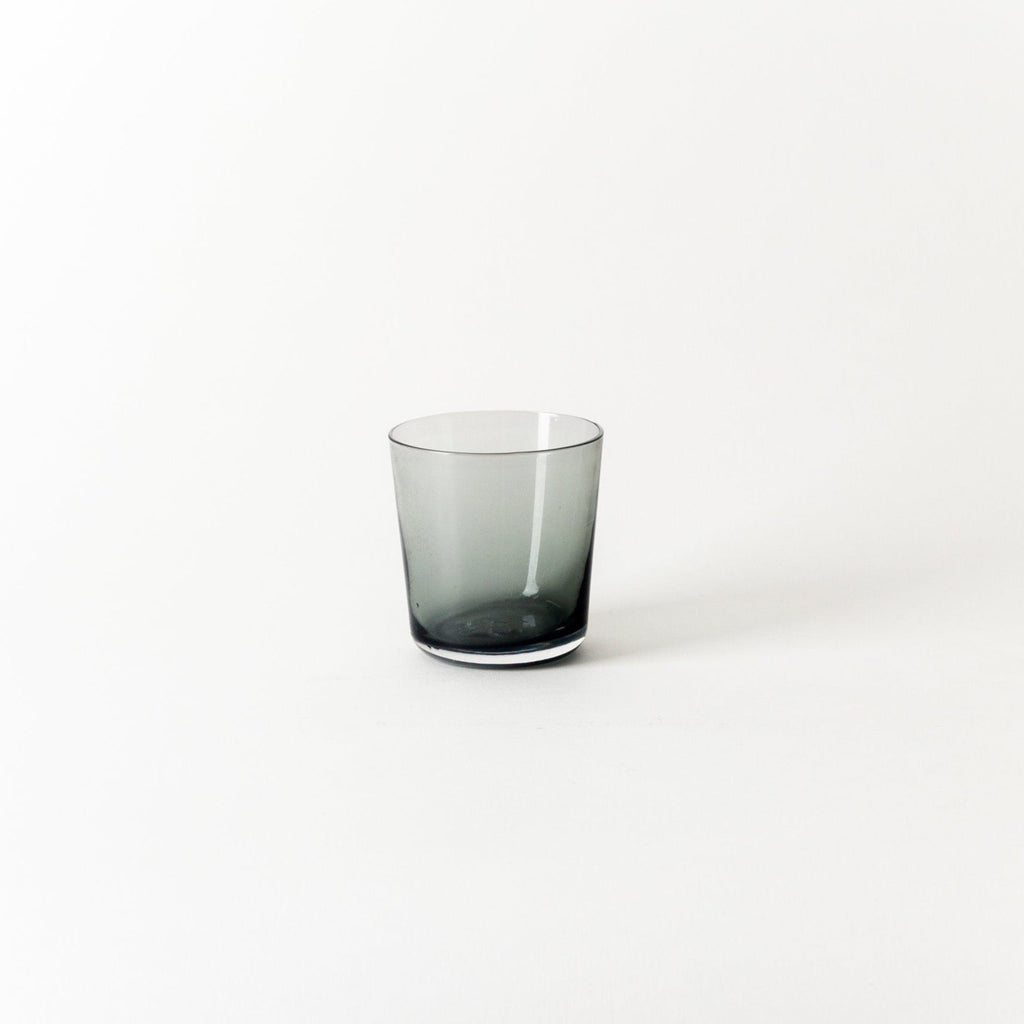 A SHORT GLASS sitting on a white surface by GARY BODKER DESIGNS at the Gestalt Haus.
