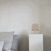 A white SPHERE vase couch with a lamp on top of it by 101 COPENHAGEN in the style of Gestalt.