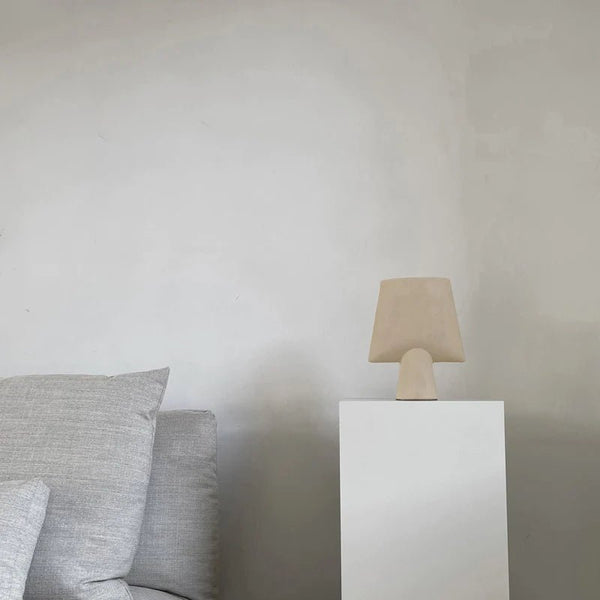A white SPHERE vase couch with a lamp on top of it by 101 COPENHAGEN in the style of Gestalt.