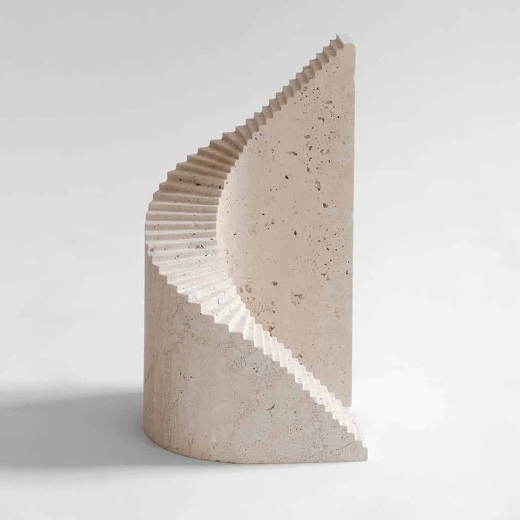 A SPIRAL and FLIGHT SCULPTURES crafted from travertine, showcased on a white surface by ORIGIN MADE.