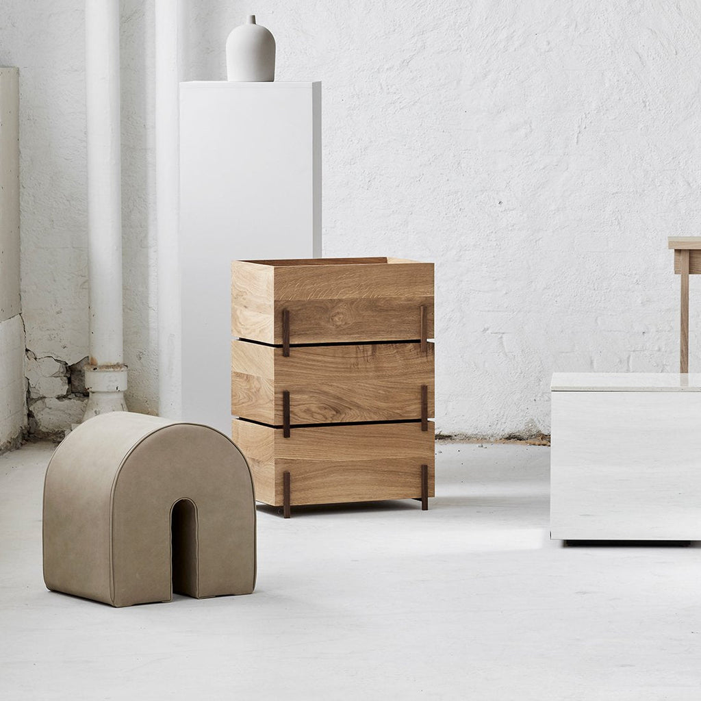 A group of stack storage boxes by KRISTINA DAM STUDIO in a white room with a gestalt haus aesthetic.