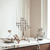 A marble counter showcases a STOFF NAGEL silver candle holder, creating a Gestalt Haus feel.