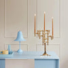 A blue STAND desk with a candle holder and a lamp by STOFF NAGEL that embodies the essence of Gestalt Haus.