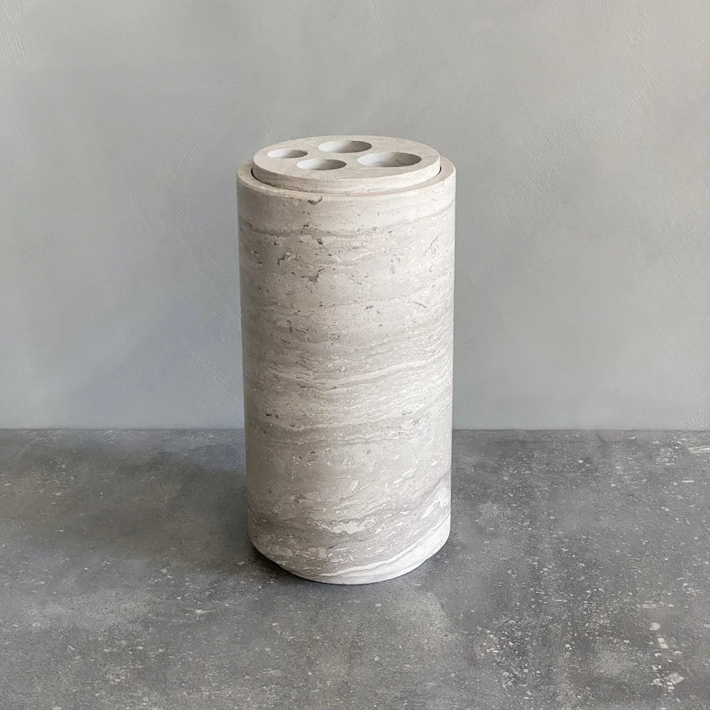 A Gestalt Haus STEM Vase from Brandt Collective resting on a concrete surface.