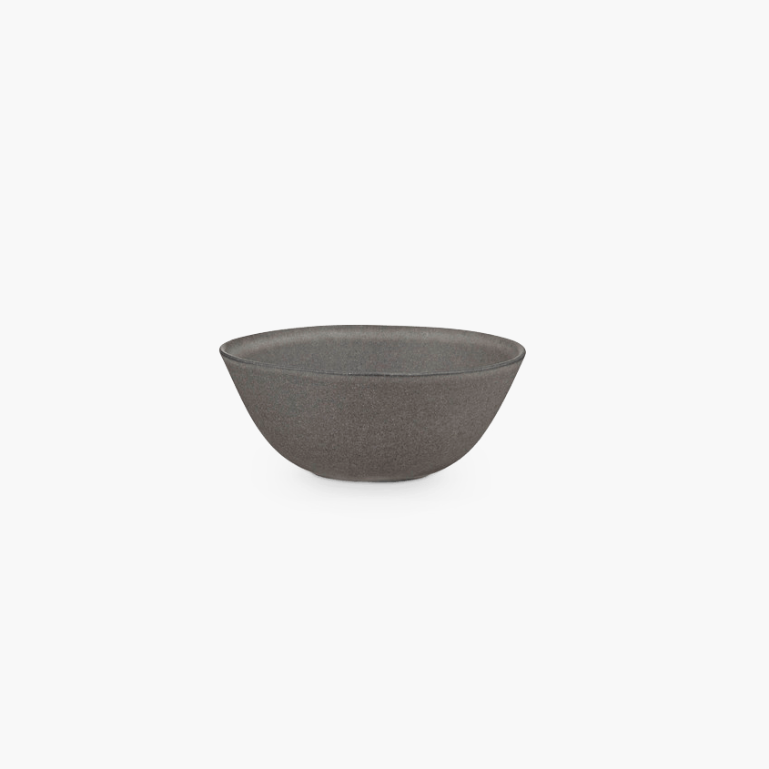 A small Gestalt Haus STUDIO TABLEWARE bowl on a black background by KLASSIK STUDIO.