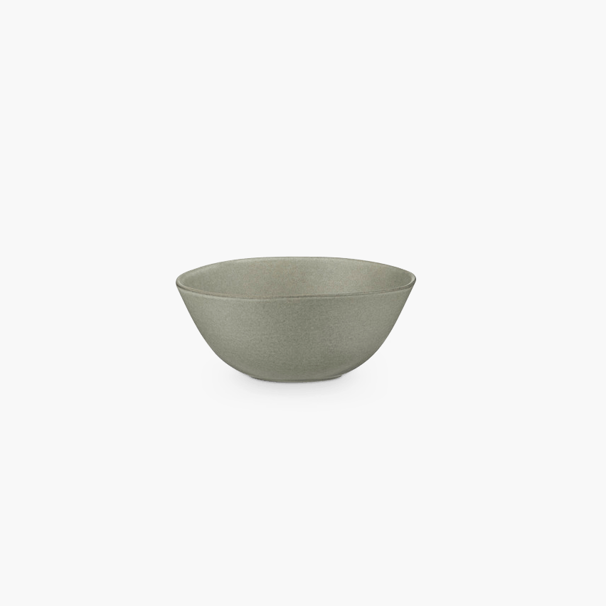 A white bowl from the brand KLASSIK STUDIO on a black background.