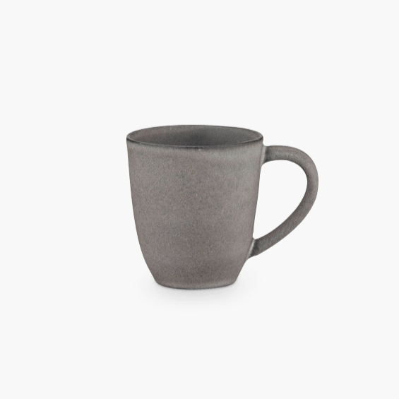 A grey STUDIO TABLEWARE mug on a black background by KLASSIK STUDIO, inspired by the principles of Gestalt Haus.