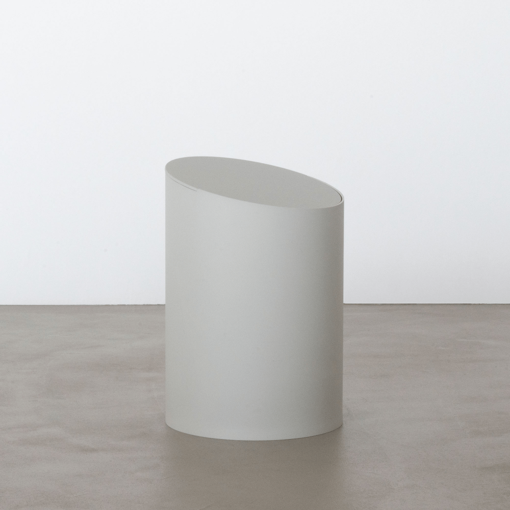 A white MOHEIM SWING BIN sitting on a concrete floor at Gestalt Haus.