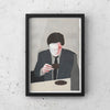 A framed print of TAKING A BREAK SERIES "AFTER DINNER" by CAN FAMILY, featuring a man in a suit sitting at a Gestalt Haus table.