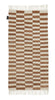 A brown and white THE ABEBA RUG with fringes from SERA HELSINKI, available at Gestalt Haus.