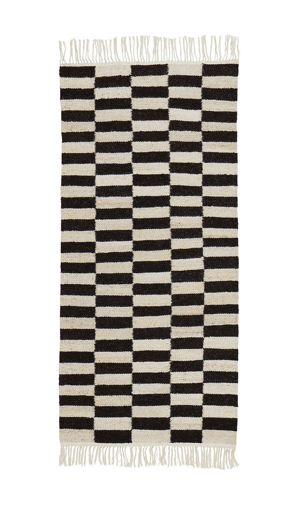 A black and white striped rug on a white background, THE ABEBA RUG by SERA HELSINKI, with a Gestalt touch.