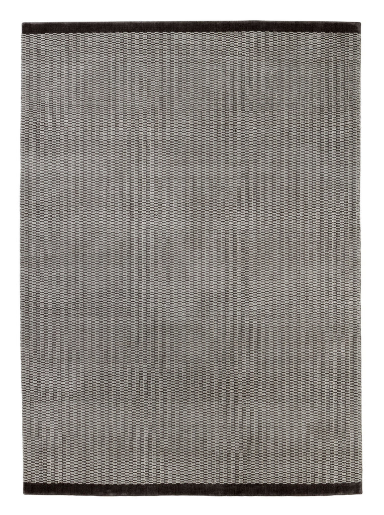 A black and white Gestalt Haus rug by FABULA LIVING.