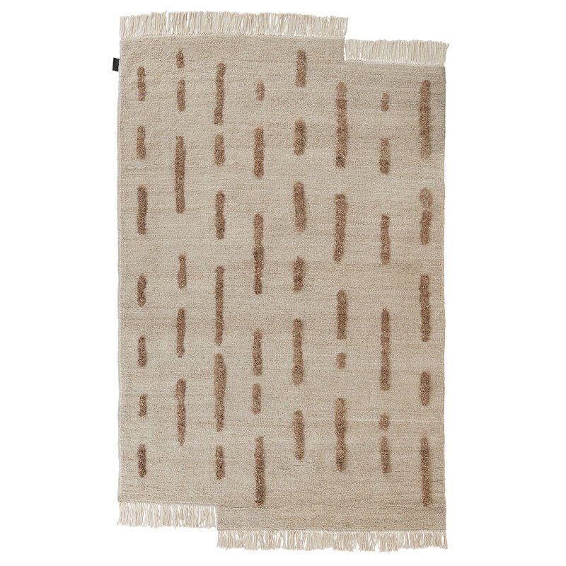 A SERA HELSINKI rug with fringes on a white background, named THE LAINE RUG from Gestalt Haus.